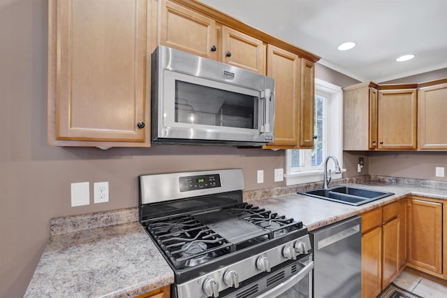 kitchen with light countertops, recessed lighting, appliances with stainless steel finishes, and a sink