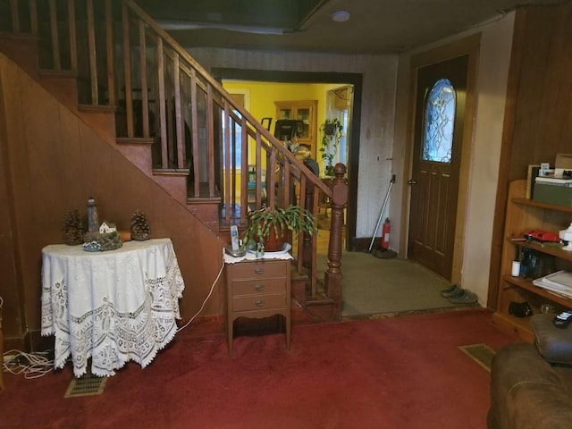 carpeted entryway with stairway