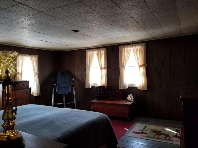 bedroom featuring wood walls