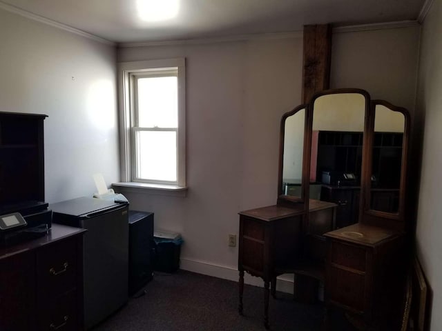 office space with baseboards, dark carpet, and ornamental molding