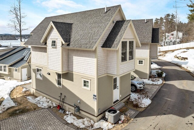 109 Weirs Blvd Unit 5, Laconia, NH 03246 - view of snow covered exterior with roof with shingles and central air condition unit