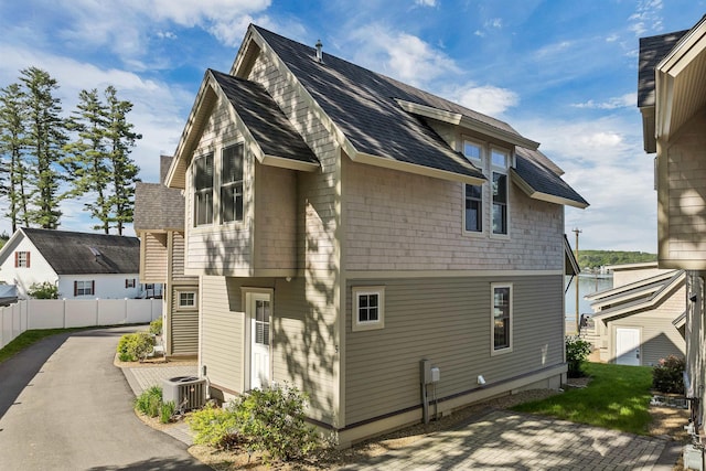 109 Weirs Blvd Unit 5, Laconia, NH 03246 - rear view of property featuring cooling unit and roof with shingles