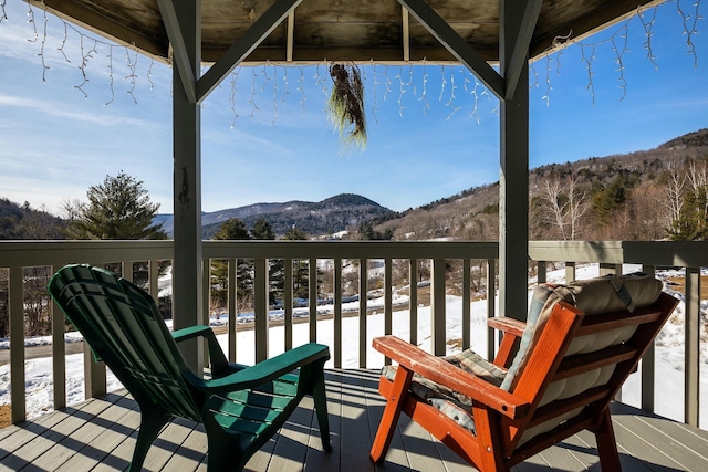 wooden deck with a mountain view