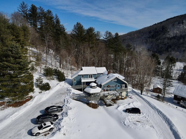 snowy aerial view with a view of trees