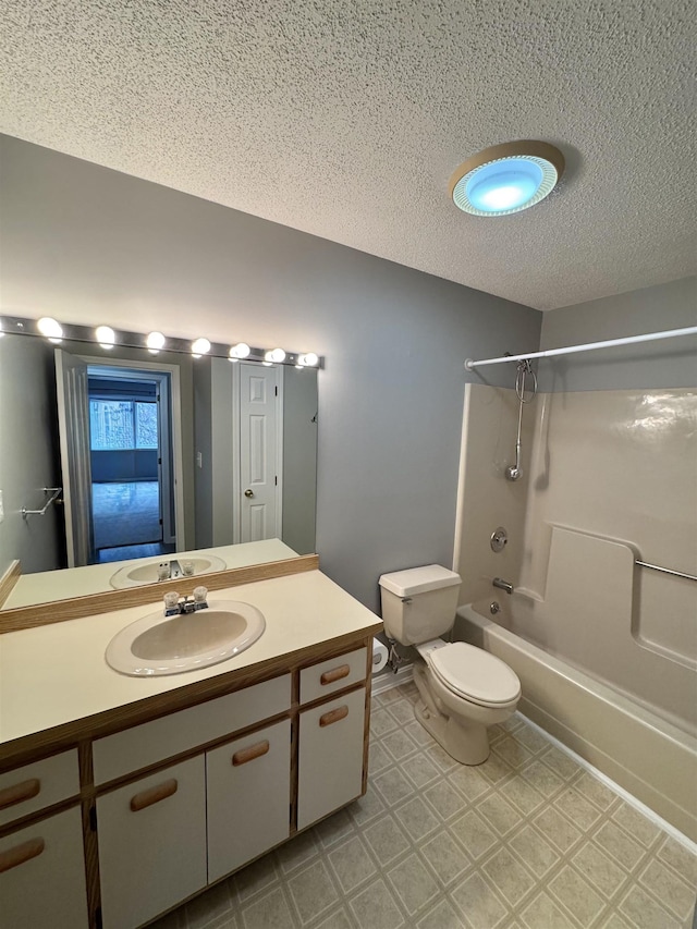 bathroom with tub / shower combination, toilet, tile patterned floors, a textured ceiling, and vanity