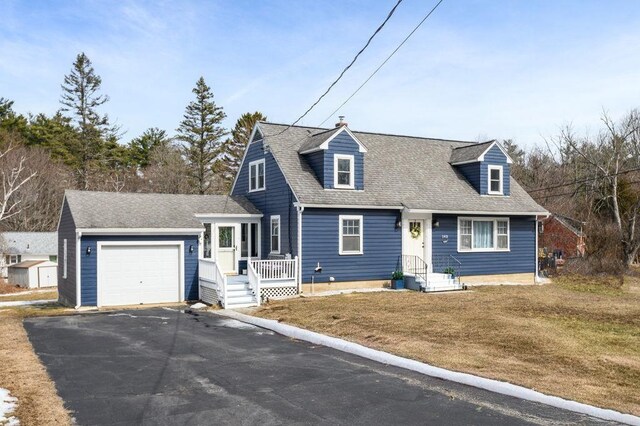 cape cod house featuring aphalt driveway, a garage, and roof with shingles