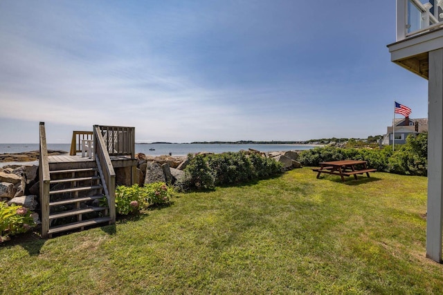 view of yard featuring a water view and stairs