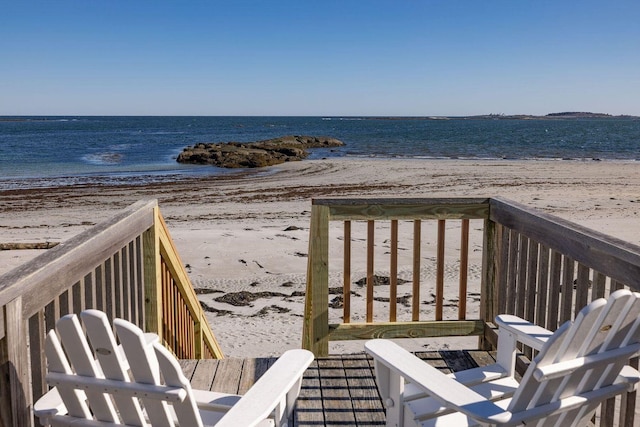 exterior space featuring a beach view and a water view