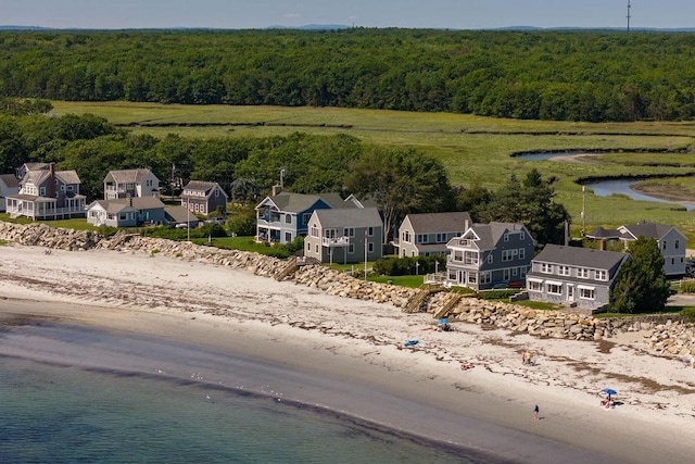 bird's eye view with a wooded view and a water view