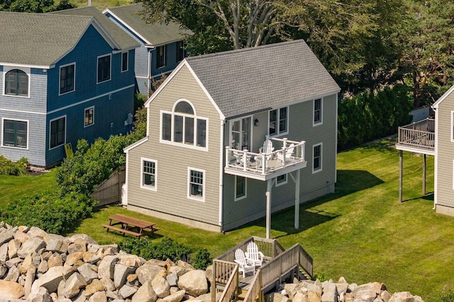 back of house featuring a yard and a deck