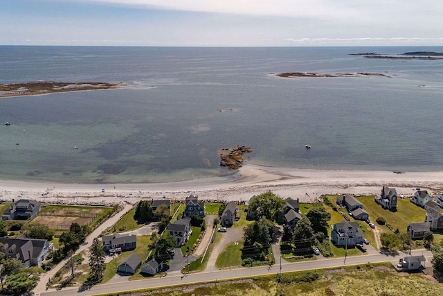 aerial view with a water view and a beach view