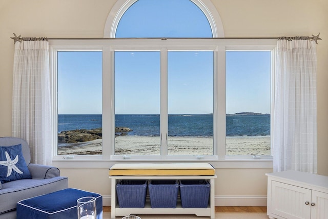 sunroom / solarium featuring a water view