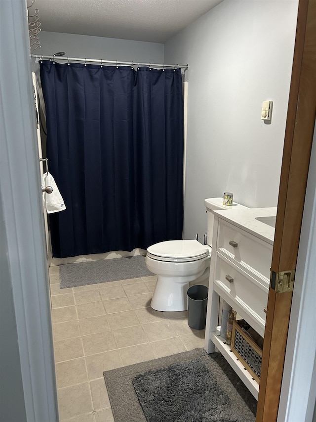 bathroom with toilet, tile patterned flooring, a shower with curtain, and vanity