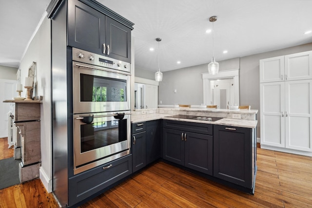 51 E Derry Rd, Derry, NH 03038 - kitchen with light stone countertops, stainless steel double oven, dark wood finished floors, a peninsula, and black electric stovetop