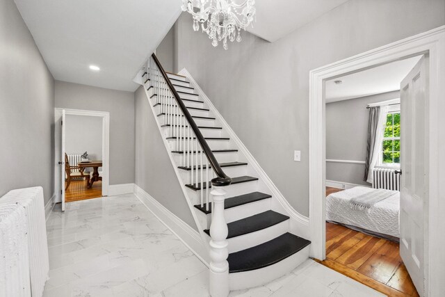 51 E Derry Rd, Derry, NH 03038 - staircase featuring radiator, baseboards, a chandelier, recessed lighting, and marble finish floor