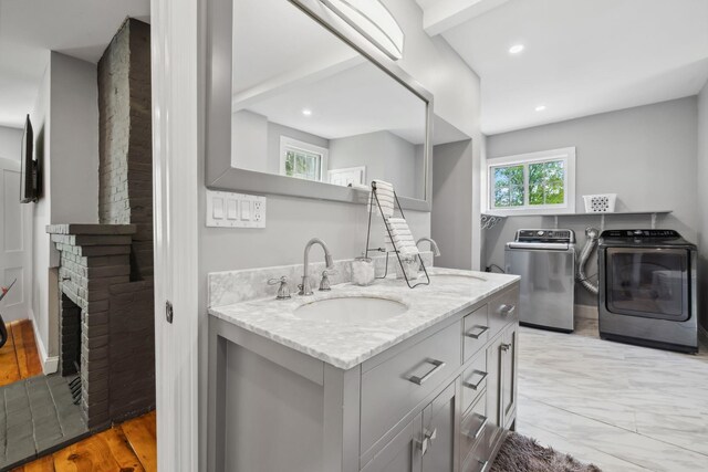 51 E Derry Rd, Derry, NH 03038 - bathroom with vanity, recessed lighting, marble finish floor, a brick fireplace, and independent washer and dryer