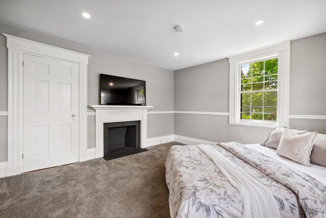 51 E Derry Rd, Derry, NH 03038 - bedroom with a fireplace with flush hearth, recessed lighting, baseboards, and carpet