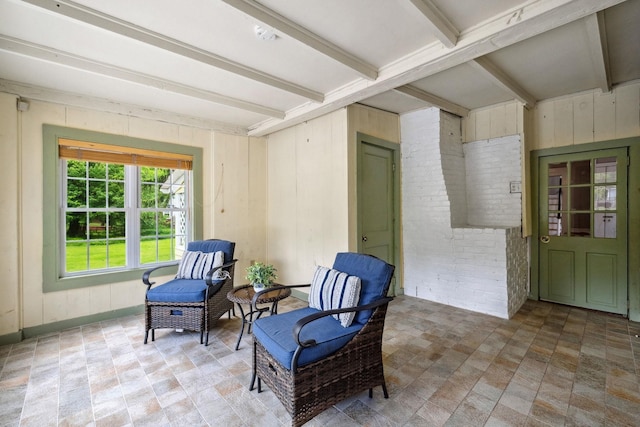 51 E Derry Rd, Derry, NH 03038 - living area with beam ceiling, wooden walls, and brick wall
