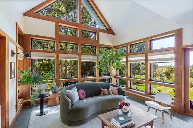 sunroom featuring high vaulted ceiling