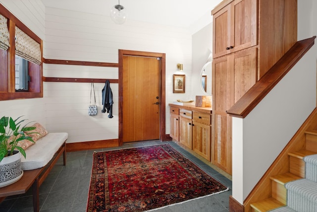 hall with wood walls and stairs