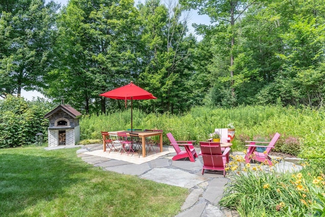 view of yard with a patio and exterior fireplace