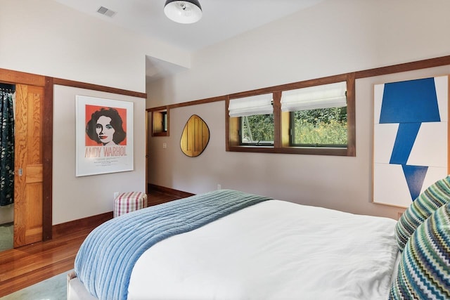 bedroom with visible vents and wood finished floors