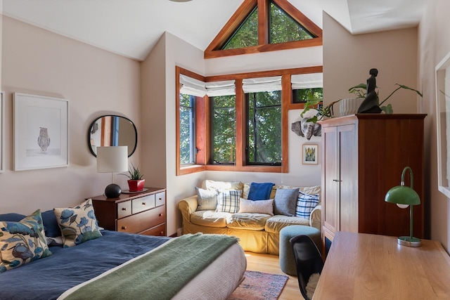 bedroom with lofted ceiling and wood finished floors