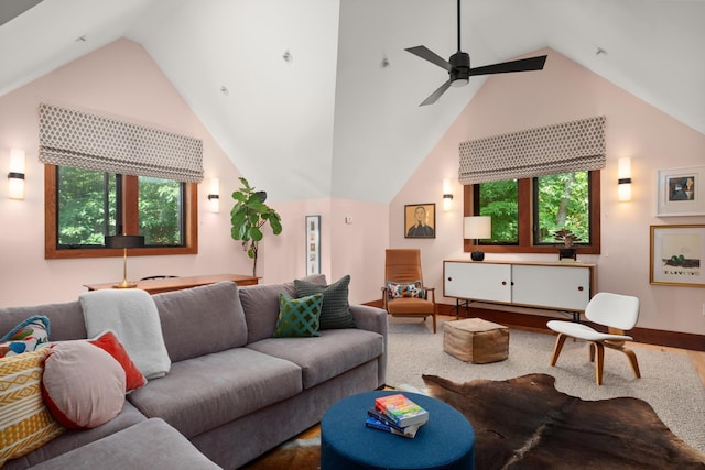 living room with a ceiling fan, a wealth of natural light, and high vaulted ceiling
