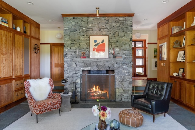 living area with tile patterned floors and a fireplace