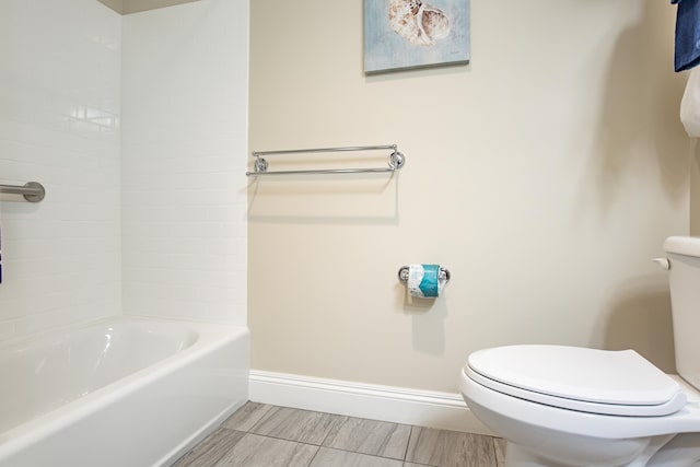 bathroom with baseboards and toilet