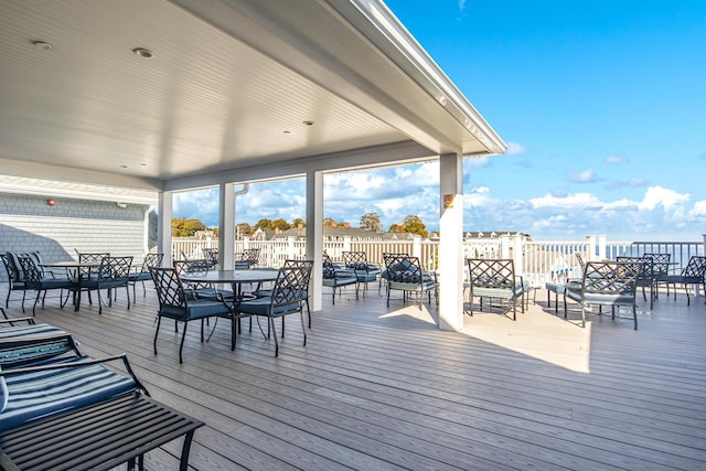 wooden terrace featuring outdoor dining space and fence