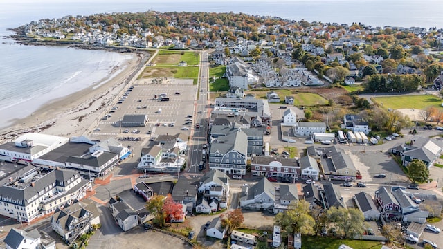 drone / aerial view with a residential view, a view of the beach, and a water view