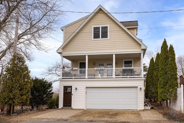 view of front of home with an attached garage, covered porch, and driveway