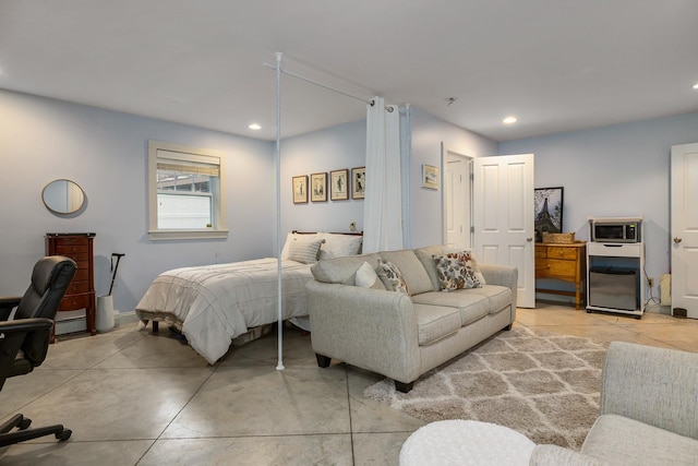 bedroom with recessed lighting, concrete floors, and a baseboard radiator