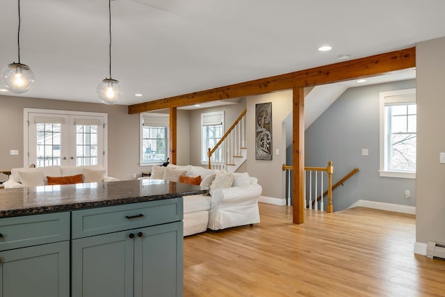 kitchen featuring open floor plan, light wood finished floors, hanging light fixtures, and recessed lighting