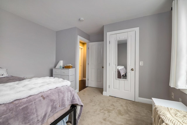 bedroom featuring baseboards and light carpet