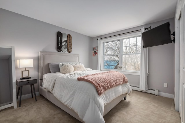 bedroom featuring light carpet, a baseboard heating unit, and baseboards
