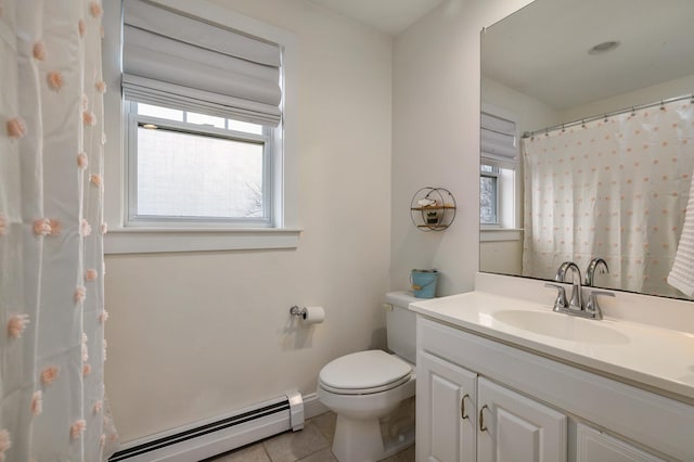 bathroom with baseboards, toilet, vanity, tile patterned floors, and a baseboard heating unit