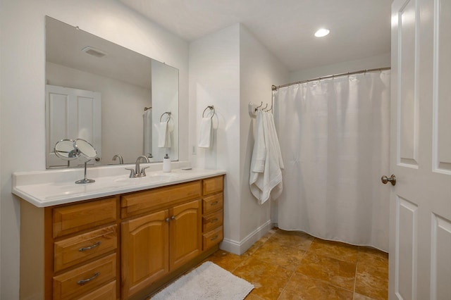 bathroom featuring baseboards and vanity