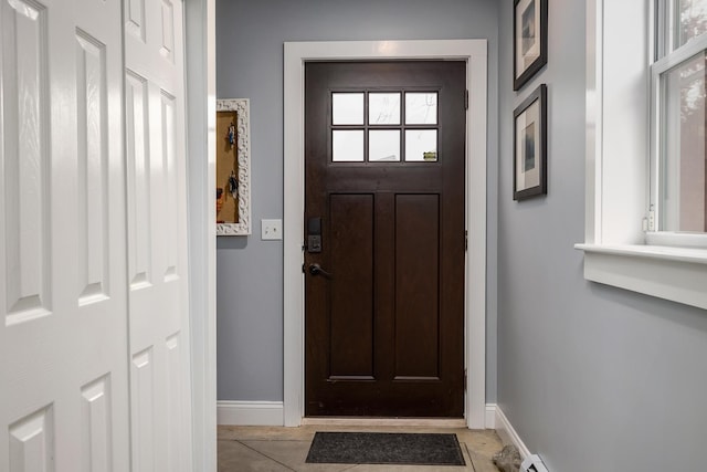 doorway featuring baseboards