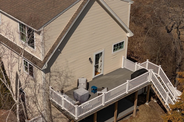 back of house with a deck