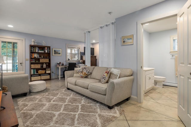 living room with a baseboard radiator, light tile patterned floors, and recessed lighting