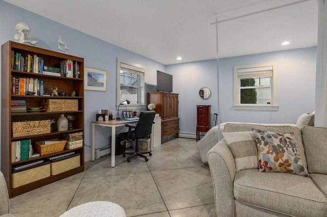 bedroom featuring concrete floors, a baseboard heating unit, and recessed lighting
