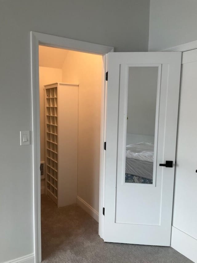 unfurnished bedroom with baseboards, carpet, and a closet