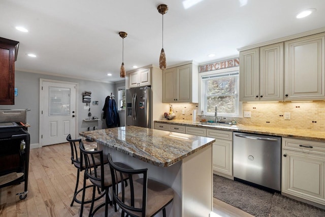 9 Sands Ter, Barnstead, NH 03225 - kitchen featuring appliances with stainless steel finishes, cream cabinetry, a sink, ornamental molding, and recessed lighting