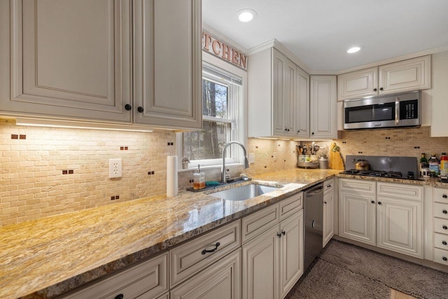 9 Sands Ter, Barnstead, NH 03225 - kitchen with appliances with stainless steel finishes, a sink, light stone counters, decorative backsplash, and recessed lighting