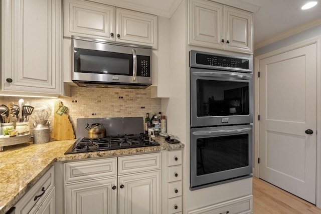 9 Sands Ter, Barnstead, NH 03225 - kitchen featuring stainless steel appliances, backsplash, crown molding, light wood-style flooring, and light stone counters