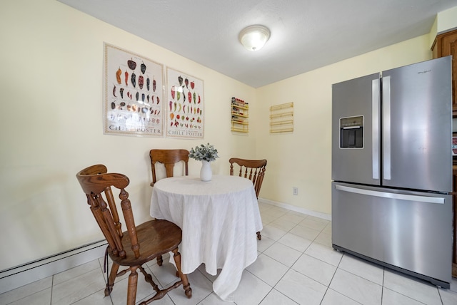 dining room featuring light tile patterned floors and baseboards
