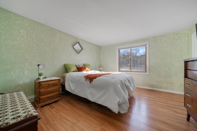 bedroom with wood finished floors and baseboards