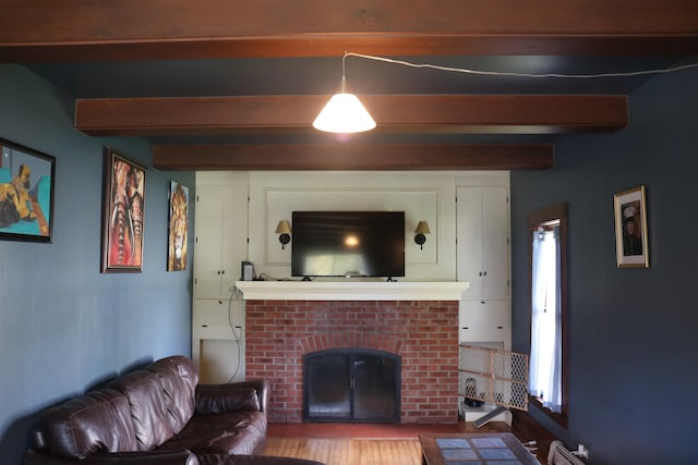 63 Province St, Richford, VT 05476 - living area with beam ceiling, wood finished floors, and a fireplace